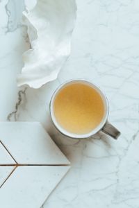 Artistic flatlay featuring a ceramic mug on a marble surface.